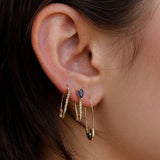 Model wearing 14K gold diamond and sapphire drop hoop earrings.