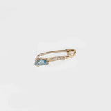 14K gold hoop earring with blue topaz drop and secure clasp closure.