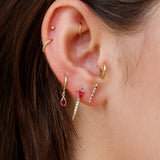 Loren Stewart Mini Ruby Diamond Safety Pin Earring worn in a layered ruby and gold ear stack