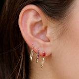 Mini Ruby Diamond Safety Pin Earring in 14k gold worn with two ruby safety pin earrings