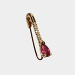 Angled view of Loren Stewart safety pin earring with pear cut ruby and natural diamonds