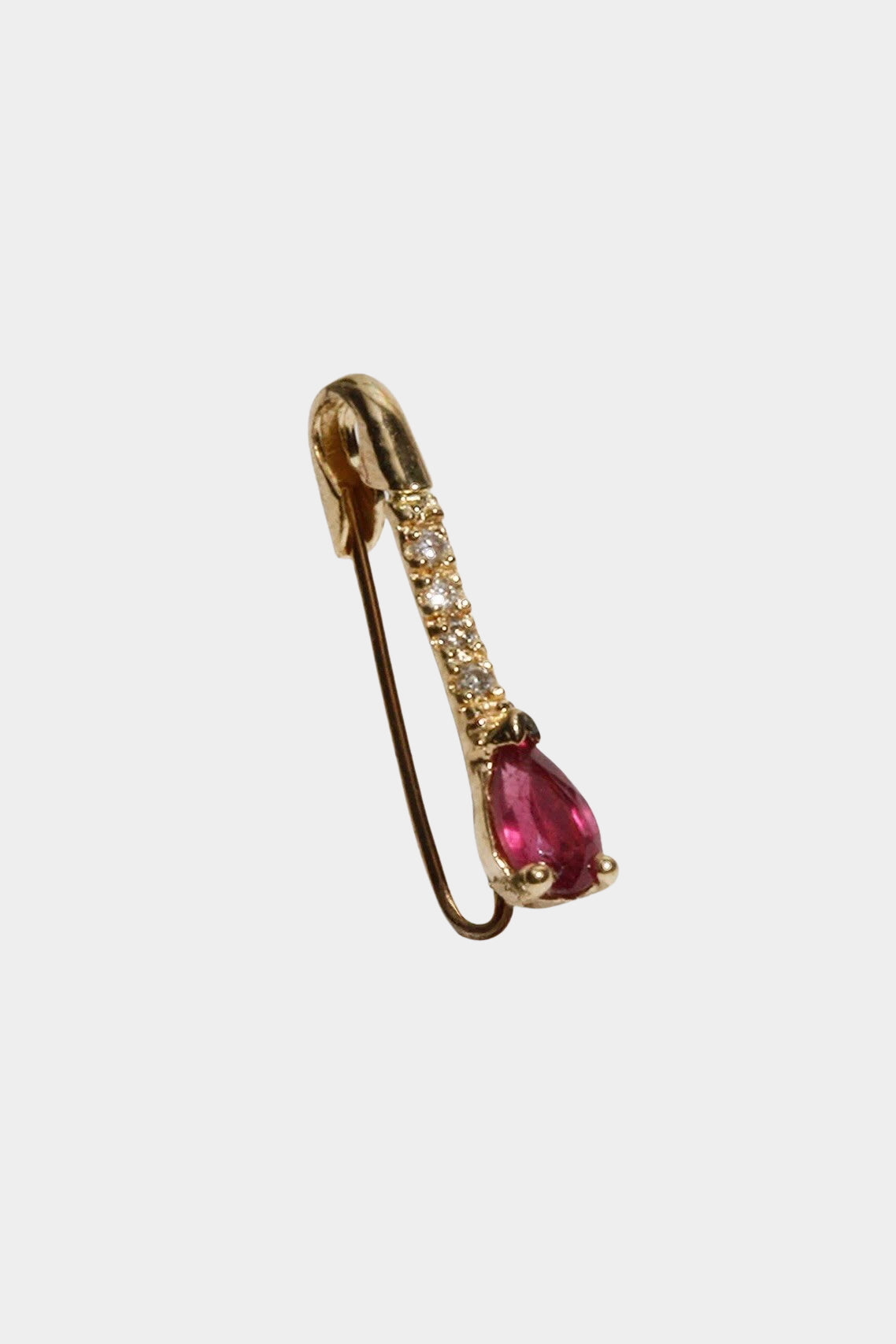 Angled view of Loren Stewart safety pin earring with pear cut ruby and natural diamonds