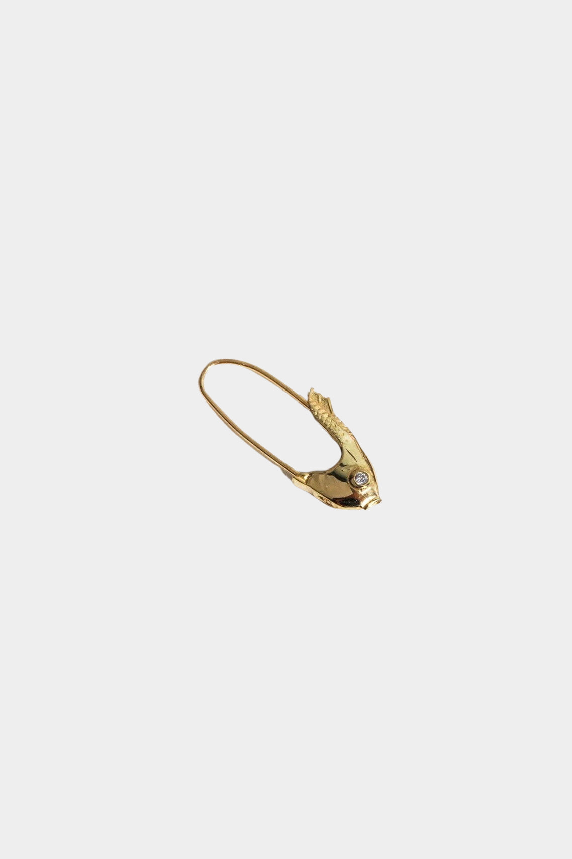 Single Loren Stewart Pisces Safety Pin Earring with a diamond eye on a light gray background