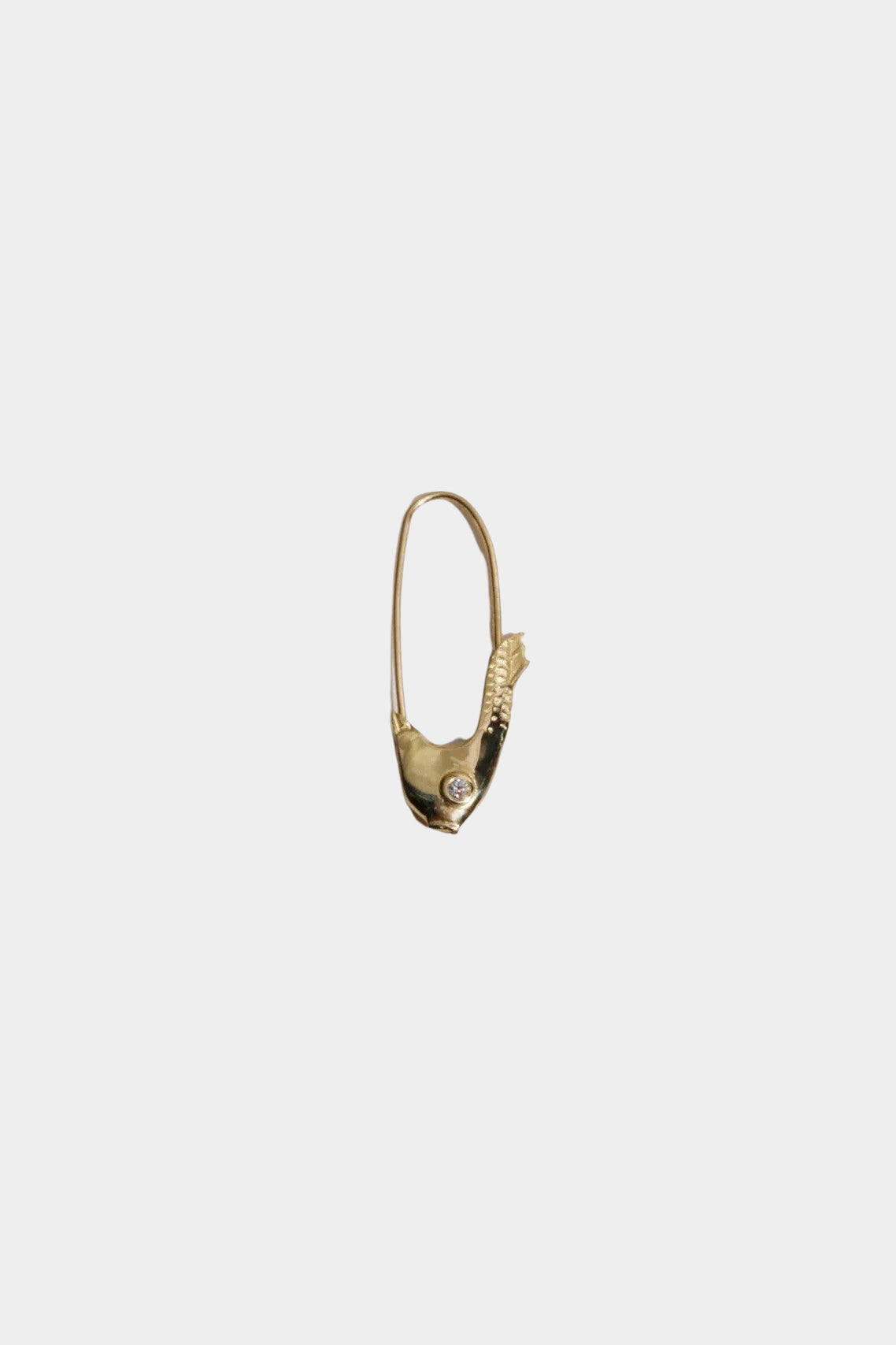 Single 14k yellow gold Pisces fish earring displayed at YUCCA Denver