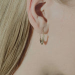 Loren Stewart Pisces Safety Pin Earring in 14k yellow gold worn on the ear