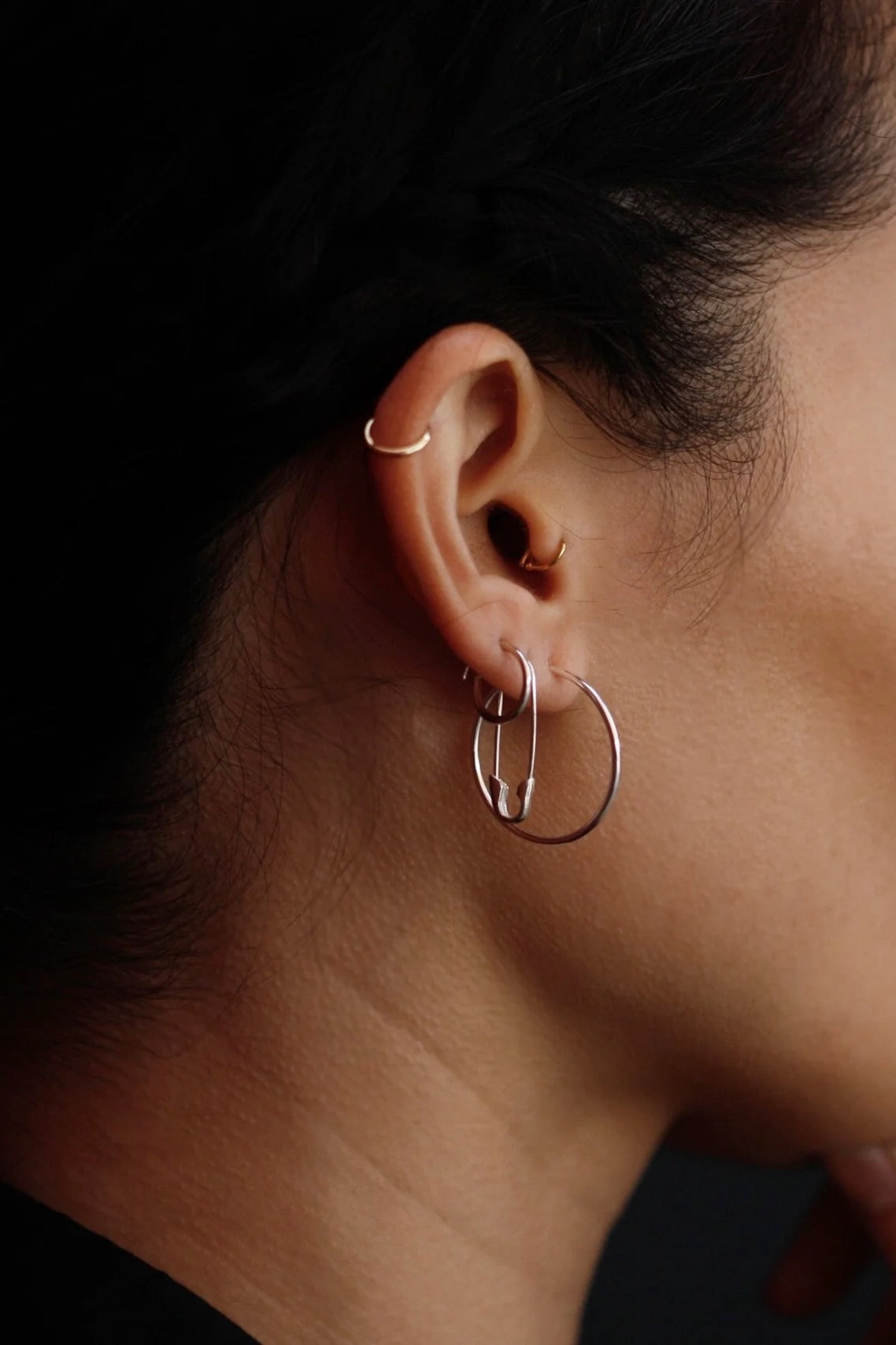 Loren Stewart sterling silver Safety Pin Earring styled with silver hoops on the ear at YUCCA Denver.