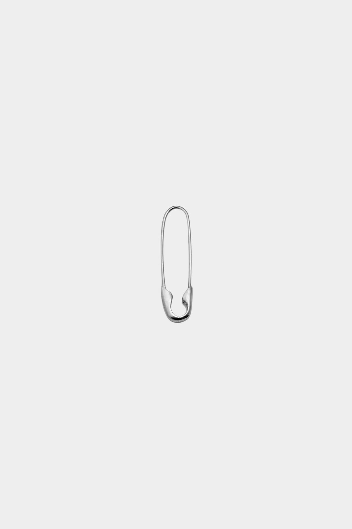 Closed Loren Stewart sterling silver Safety Pin Earring against a light gray background.