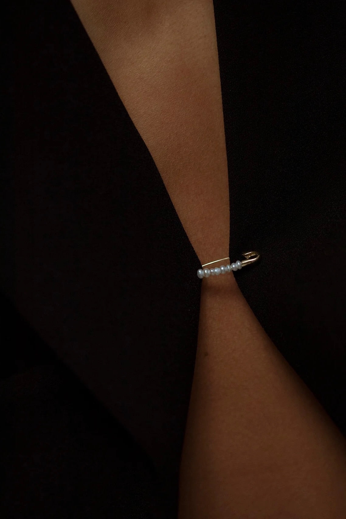 Model wearing 14K gold freshwater pearl bead hoop earring.