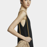 Model wearing Maria La Rosa Mini Game Bag in Biscotto as a crossbody bag