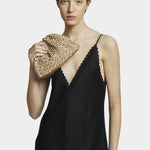 Model holding Maria La Rosa Mini Game Bag in Biscotto woven ribbon handbag