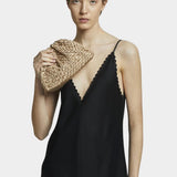 Model holding Maria La Rosa Mini Game Bag in Biscotto woven ribbon handbag