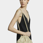 Model wearing Maria La Rosa Mini Game Bag in Satin Gold crossbody style