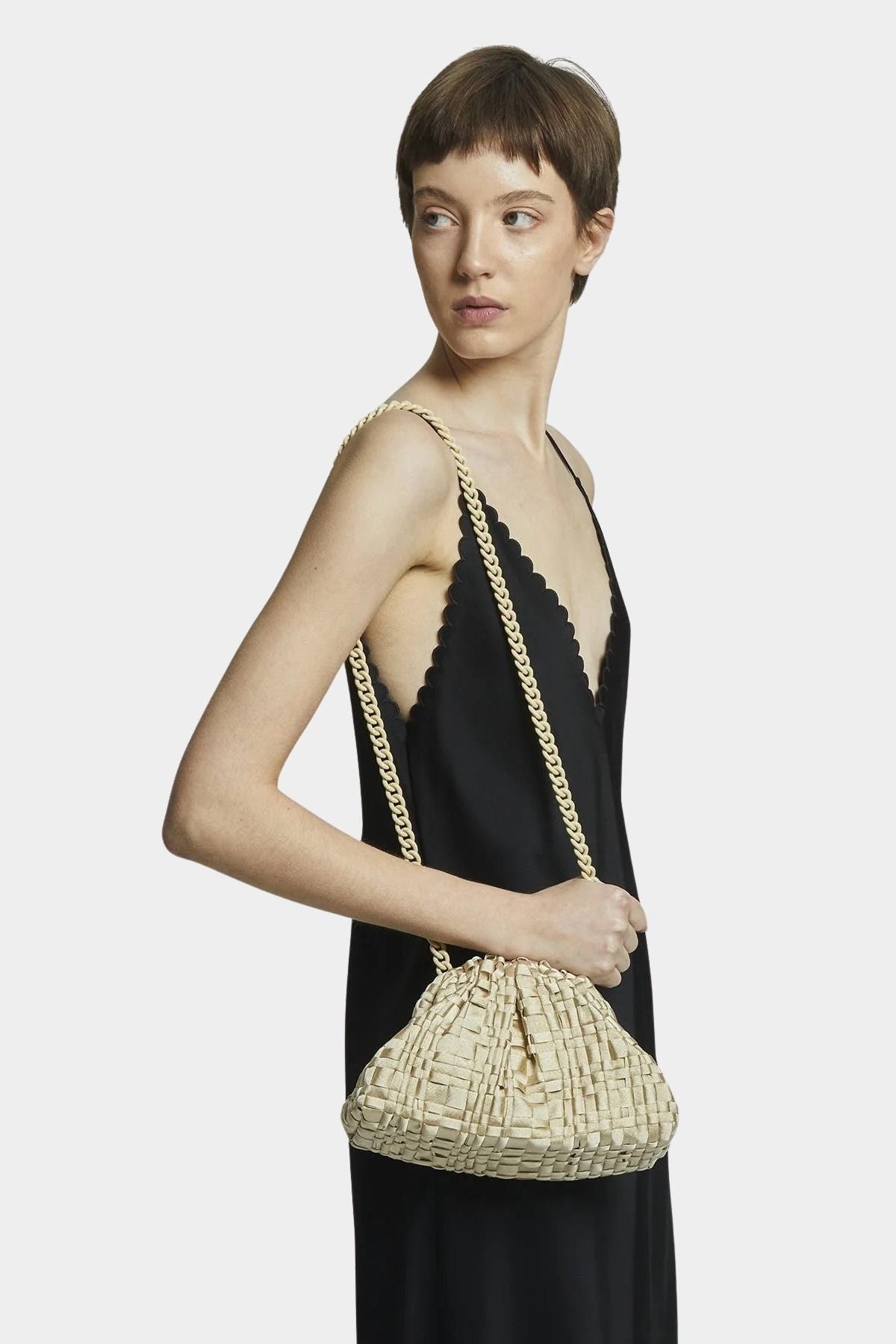 Model wearing Maria La Rosa Mini Game Bag in Satin Gold crossbody style