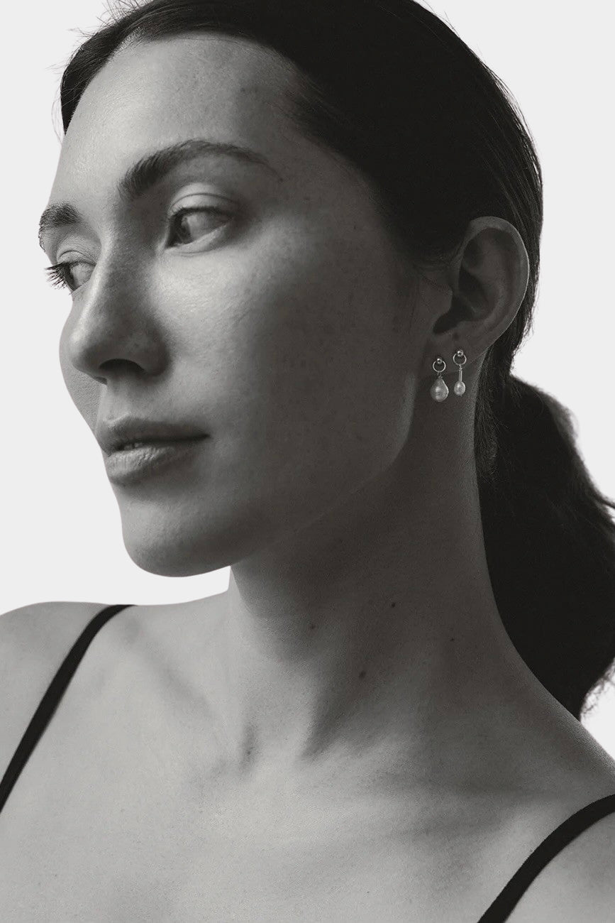 model wearing maslo balle pearl drop stud earrings sterling silver black and white