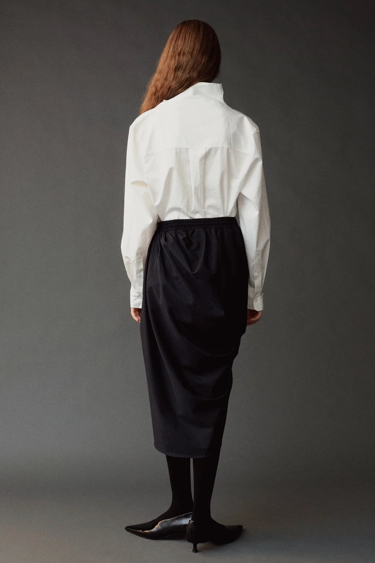 Back view of the Mijeong Park Asymmetric Cotton Shirt showing the raised collar and relaxed shape