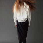 Back view of the Mijeong Park Asymmetric Cotton Shirt in white showing its rounded hem