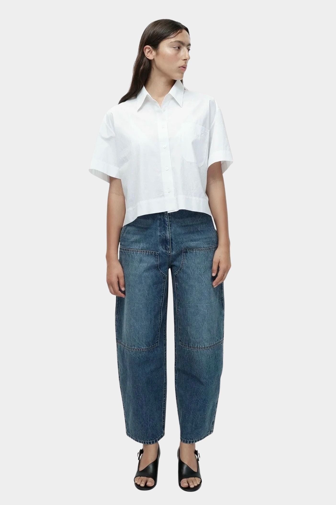 Mijeong Park blue barrel leg patch pocket denim full front view relaxed mid rise barrel jeans styled with white shirt