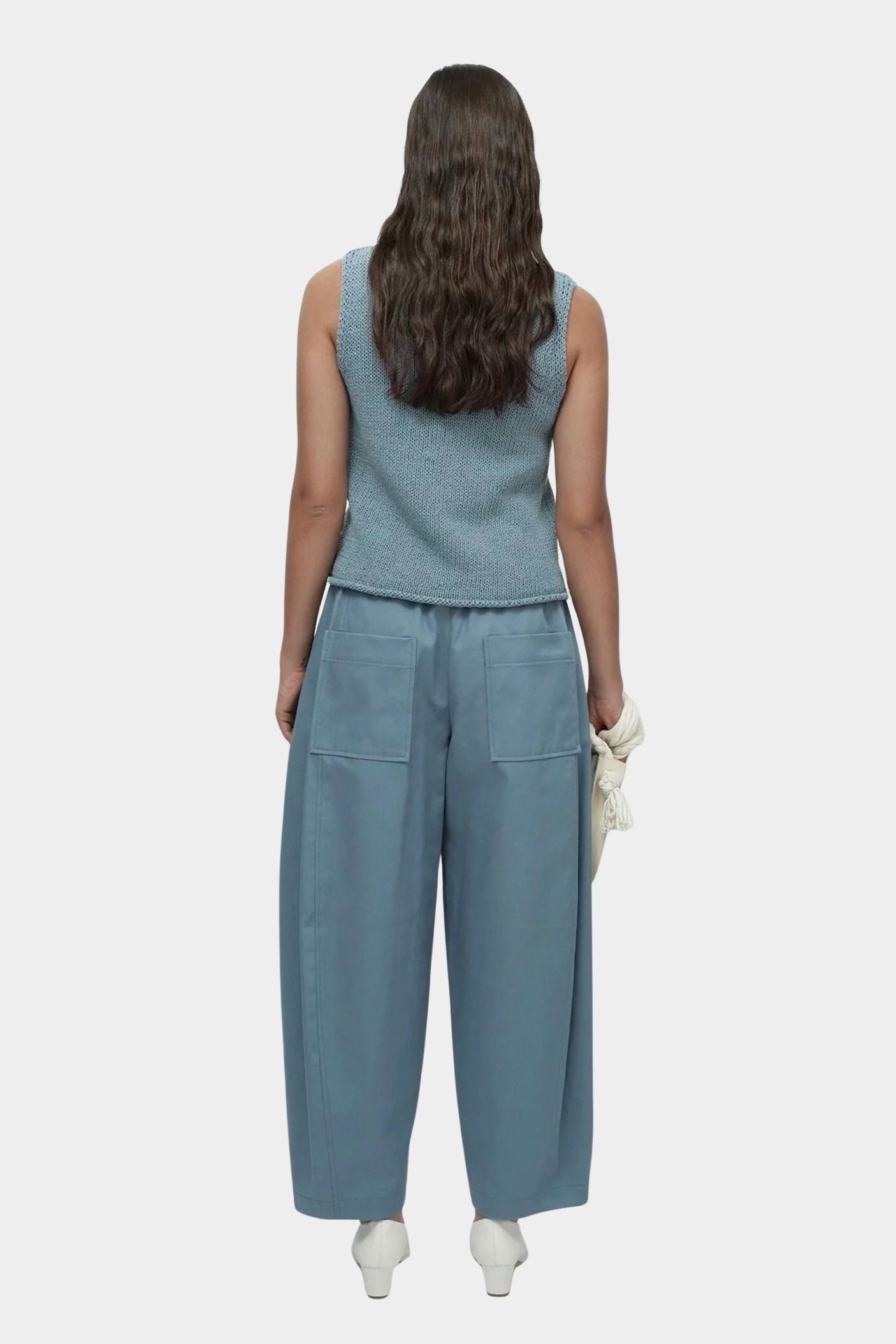 Mijeong Park blue minimal knit tank back view sleeveless cotton linen knit top with relaxed silhouette styled with wide leg trousers