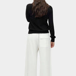 Back view of black cotton blend v neck knit top by Mijeong Park with relaxed fit