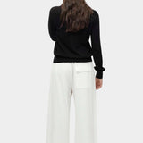 Back view of black cotton blend v neck knit top by Mijeong Park with relaxed fit