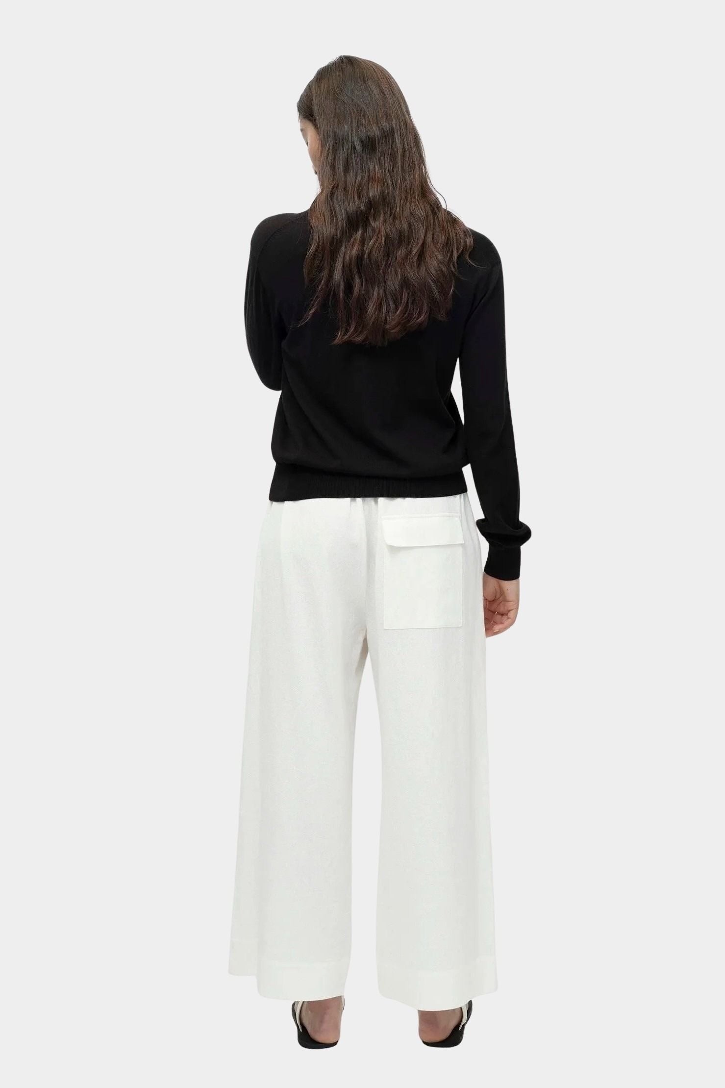Back view of black cotton blend v neck knit top by Mijeong Park with relaxed fit