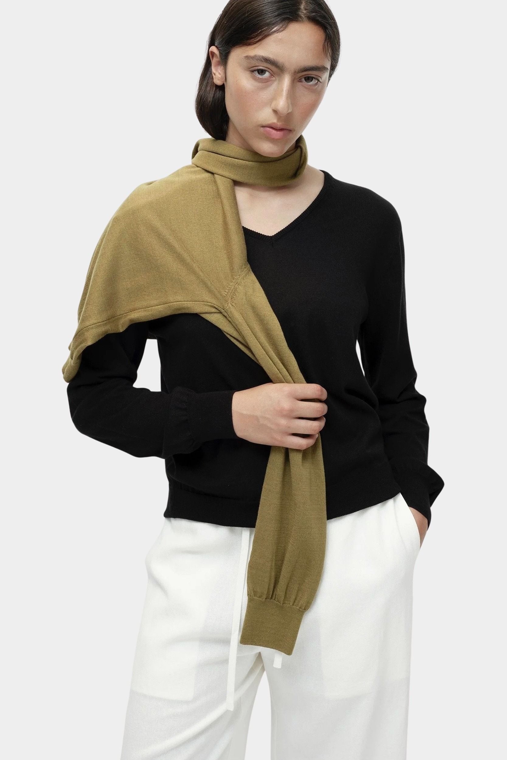 Close-up of black cotton blend v neck knit top by Mijeong Park showing v neckline detail