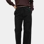 Detail of brown cotton blend v neck knit top by Mijeong Park styled with relaxed black trousers