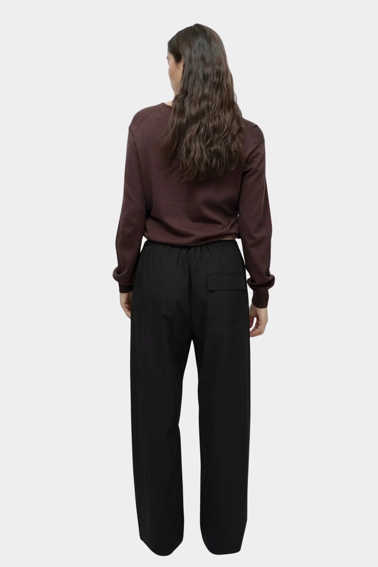 Back view of cotton blend v neck knit top in brown by Mijeong Park with relaxed fit and rib hem