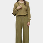 Back full view of green cotton blend v neck knit top by Mijeong Park styled with matching knit pants