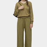 Back full view of green cotton blend v neck knit top by Mijeong Park styled with matching knit pants