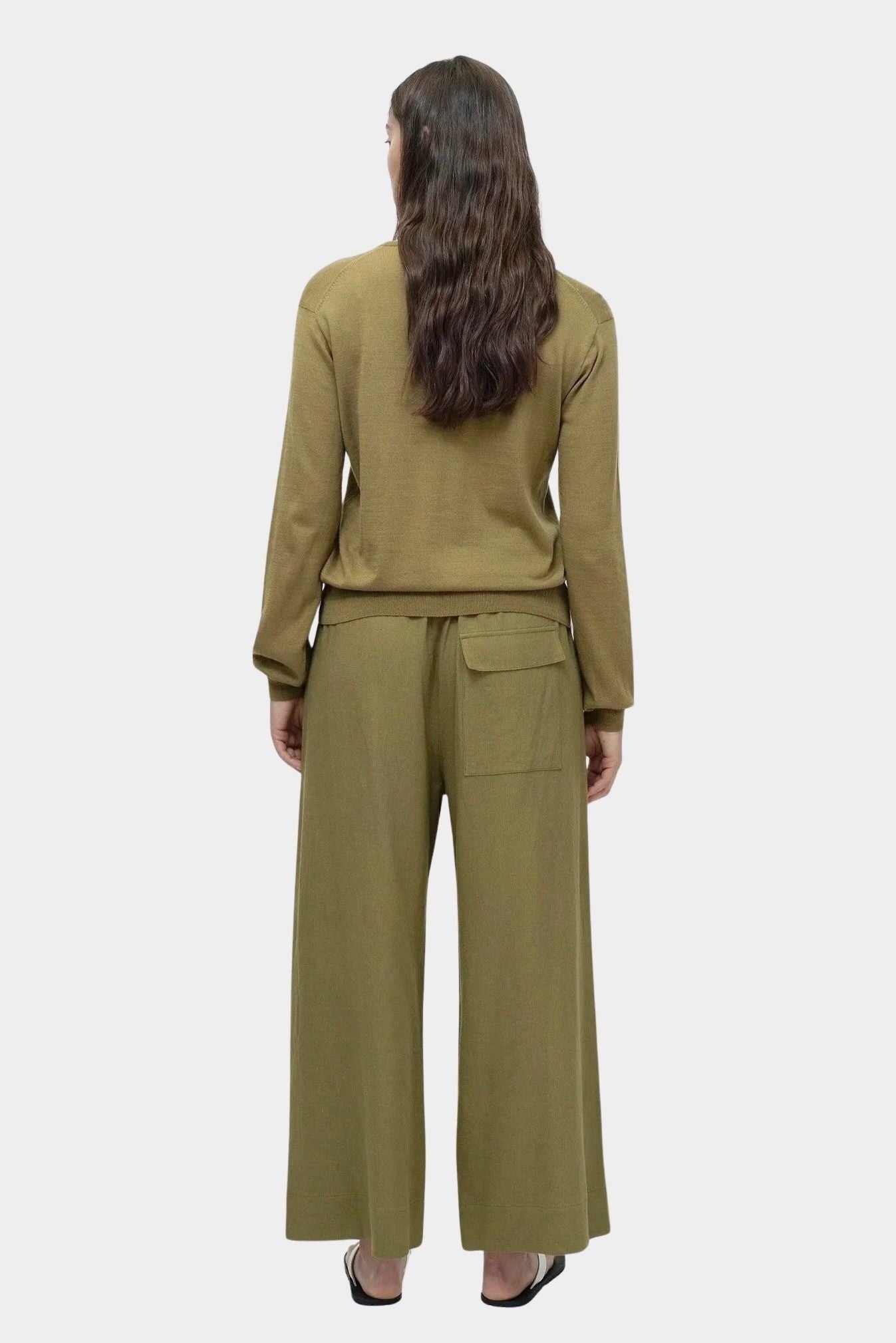 Full look of green cotton blend v neck knit top by Mijeong Park with relaxed silhouette and wide leg knit pants