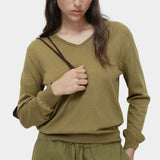 Green cotton blend v neck knit top by Mijeong Park with relaxed fit styled with matching knit pants