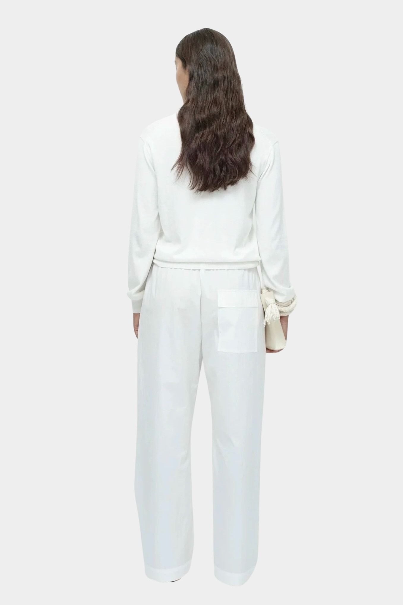 Back view of white cotton blend v neck knit top by Mijeong Park with relaxed fit