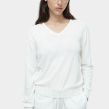 White cotton blend v neck knit top by Mijeong Park with rib hem and relaxed silhouette