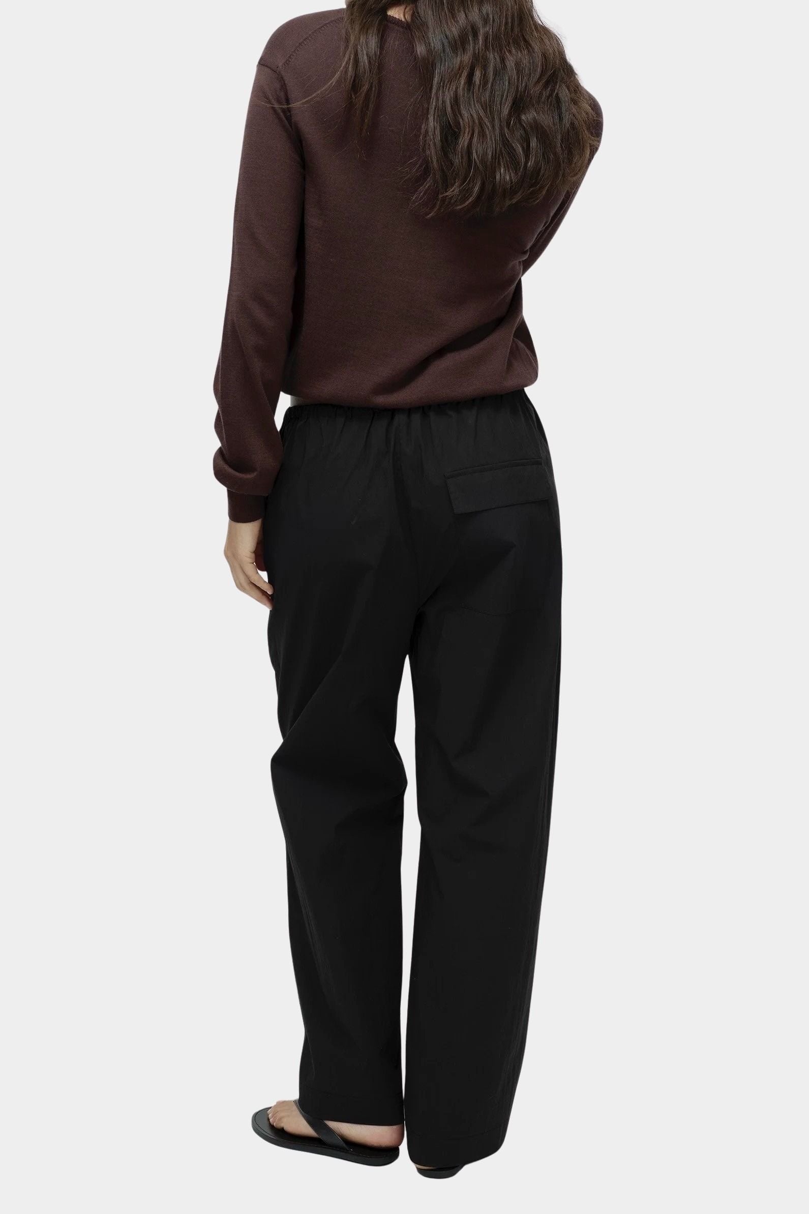 Mijeong Park black cotton drawstring pants back view wide leg relaxed silhouette womens designer trousers patch pocket detail