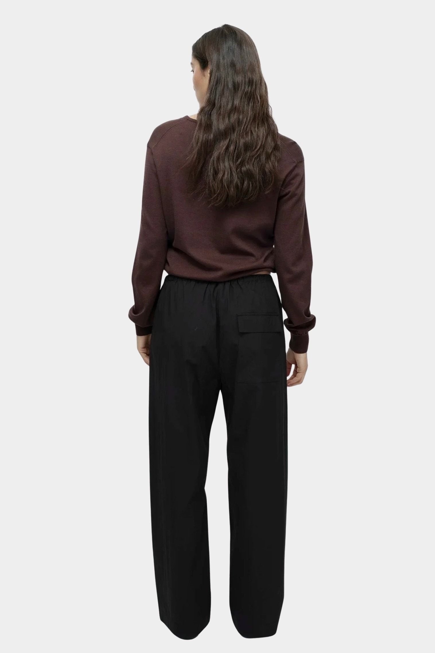 Mijeong Park black cotton drawstring pants back view relaxed wide leg elastic waist womens minimalist designer trousers patch pocket