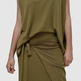 Detail view green drape back knit top by Mijeong Park showing soft knit texture and draped waist tie styling