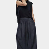 Full outfit navy drape back knit top by Mijeong Park styled with dark skirt