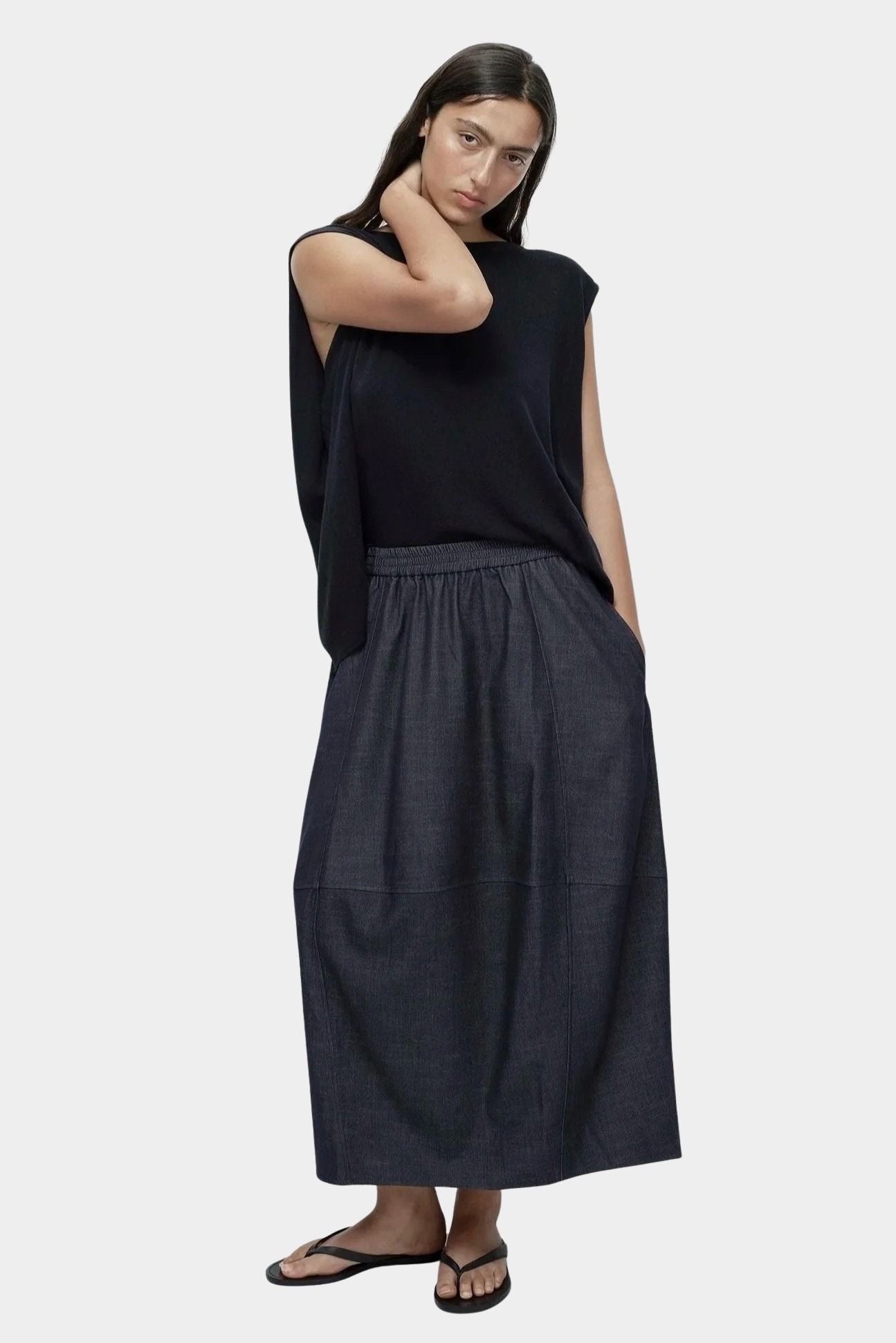 Full outfit navy drape back knit top by Mijeong Park styled with dark skirt