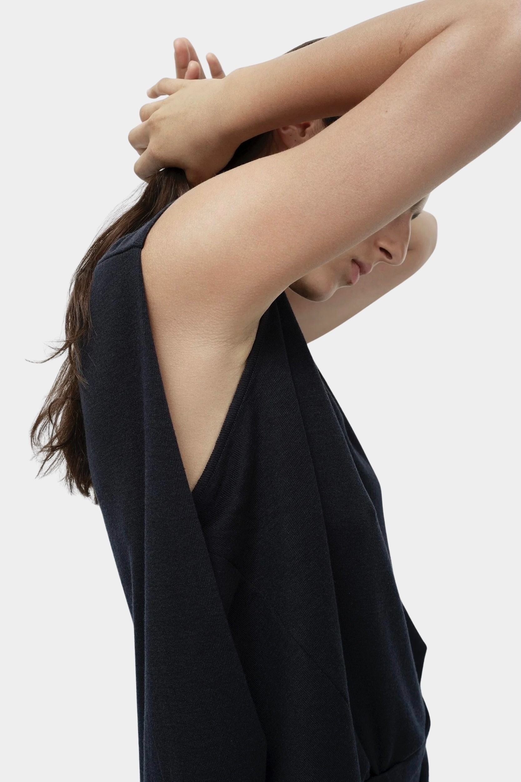 Side detail navy drape back knit top by Mijeong Park showing deep arm opening and fluid knit drape