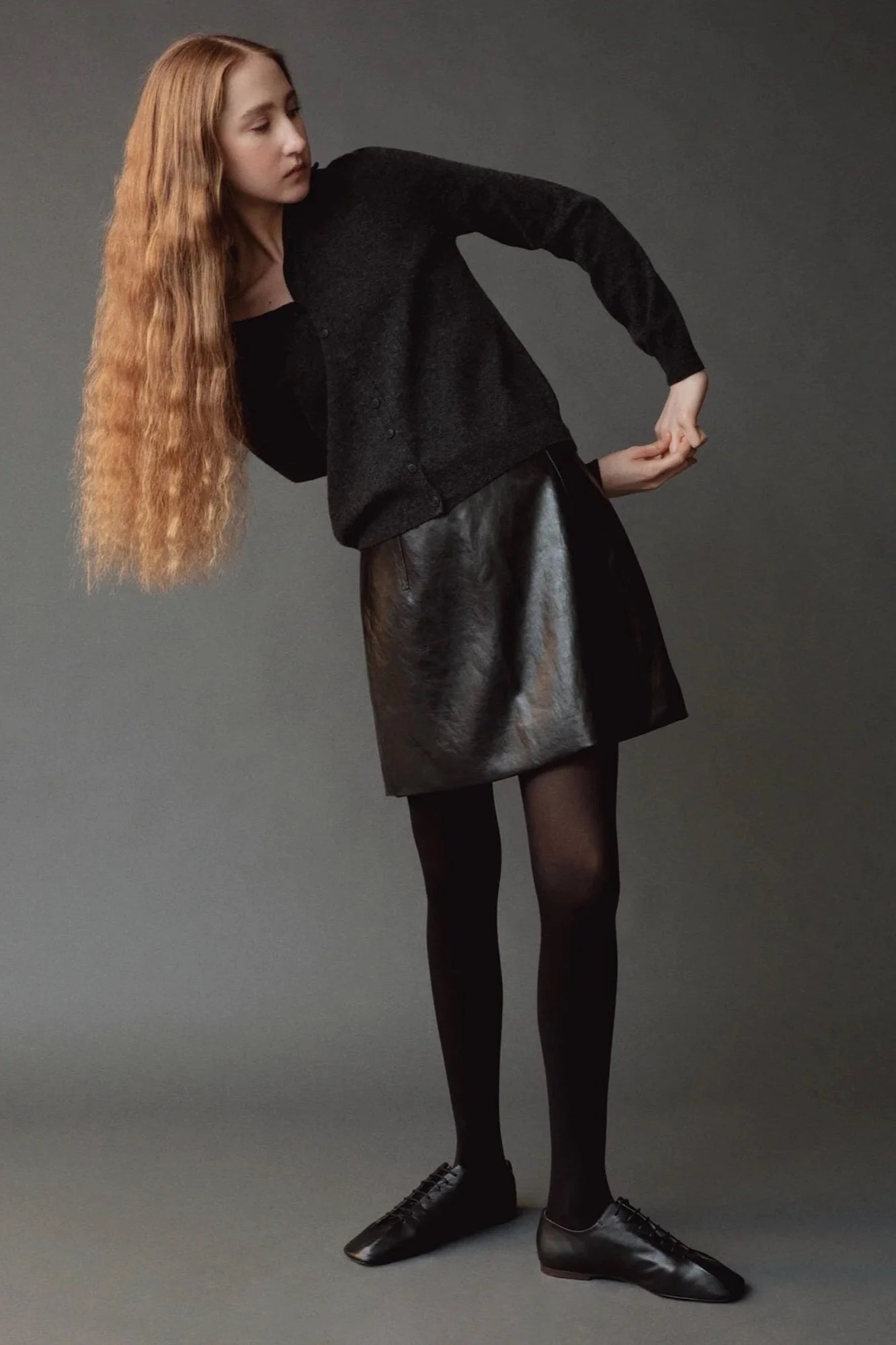 Mijeong Park Mock Neck Cardigan Charcoal styled with black leather skirt at YUCCA Denver