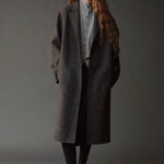 Mijeong Park Mock Neck Cardigan Gray layered under charcoal coat at YUCCA Denver