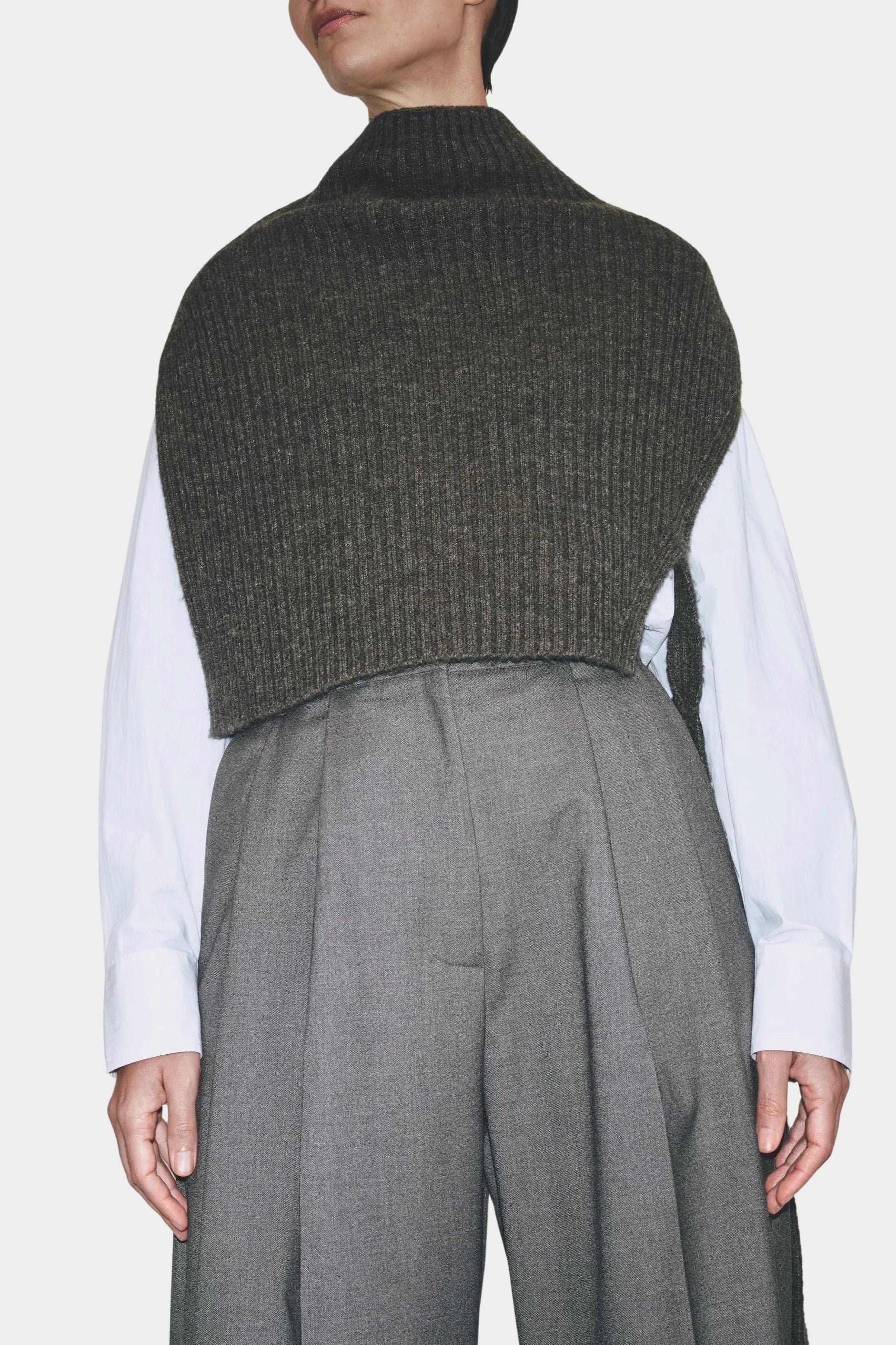 Angled view charcoal ribbed knit cropped neck warmer layered over white shirt