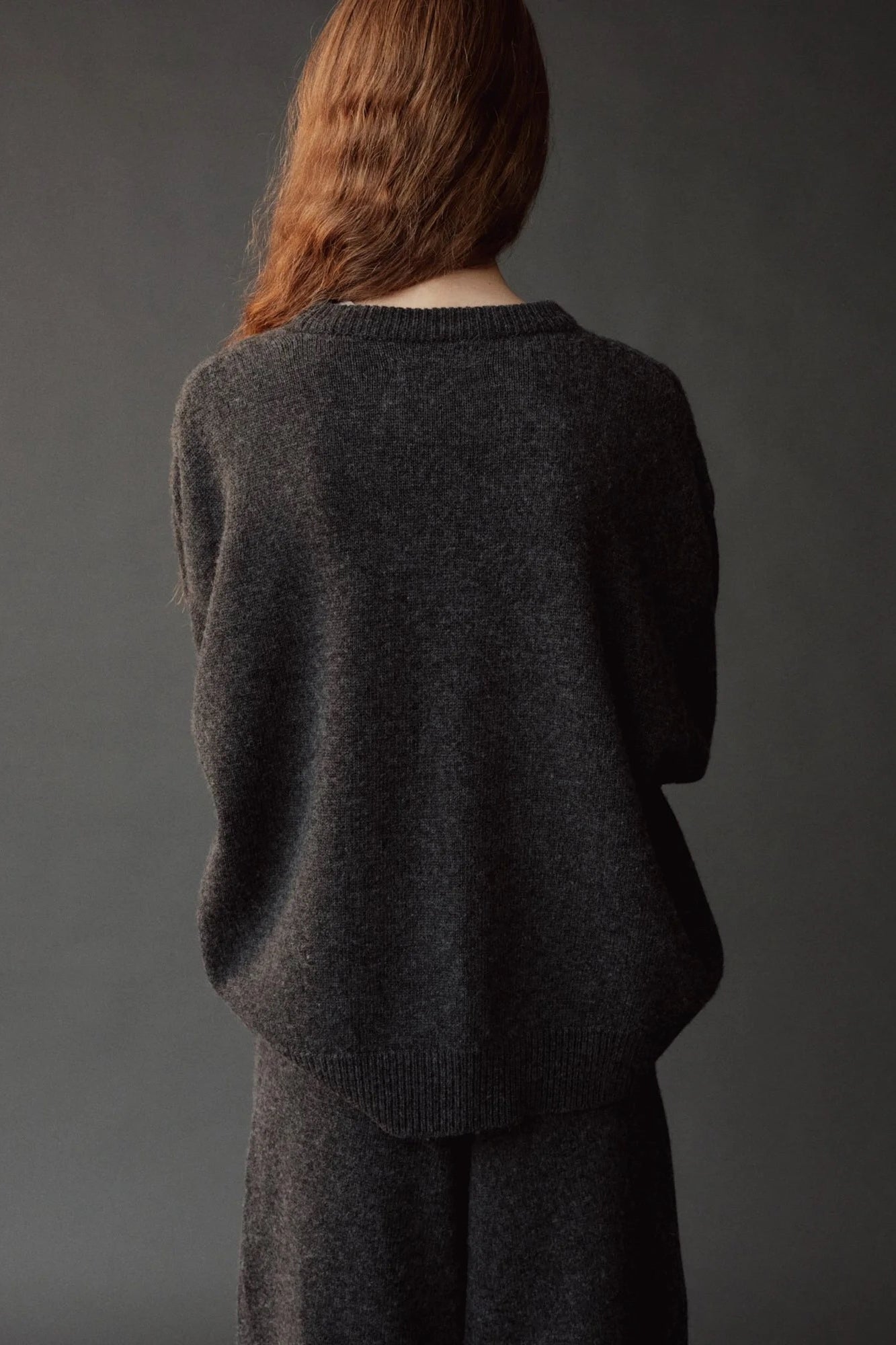 Mijeong Park Oversized Crewneck Sweater Charcoal back view showing relaxed silhouette and ribbed hem