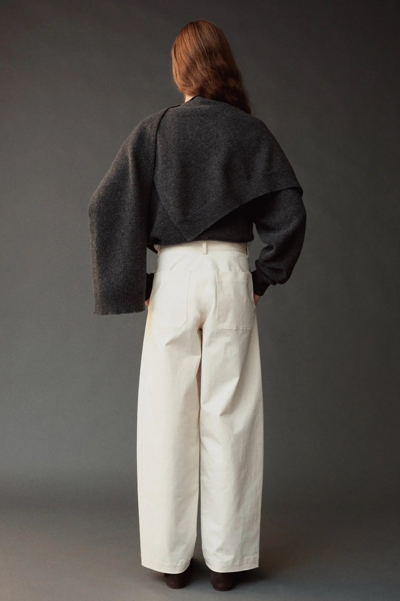 Photo 1
Mijeong Park Oversized Crewneck Sweater Charcoal styled with knit shawl and white wide leg pants, back view