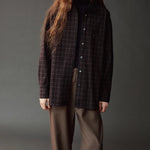 Front view of the Mijeong Park black plaid oversized shirt layered over a black turtleneck