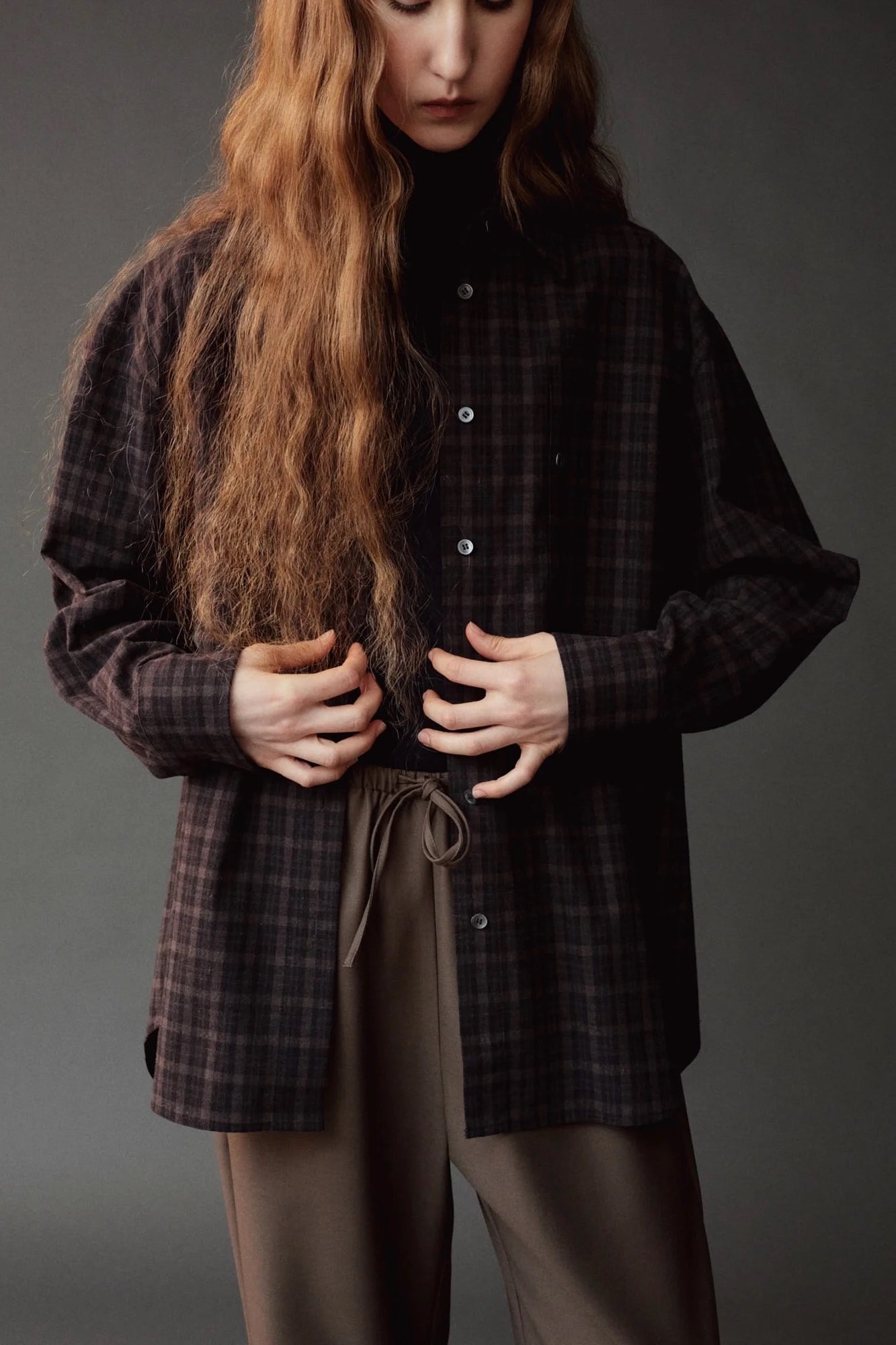 Detail of the Mijeong Park Oversized Plaid Shirt in black plaid at SHOP YUCCA in Denver
