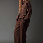 Angled view of the Mijeong Park Oversized Plaid Shirt showing its relaxed fit and long sleeves
