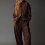 Front view of the Mijeong Park brown plaid shirt styled with relaxed brown trousers