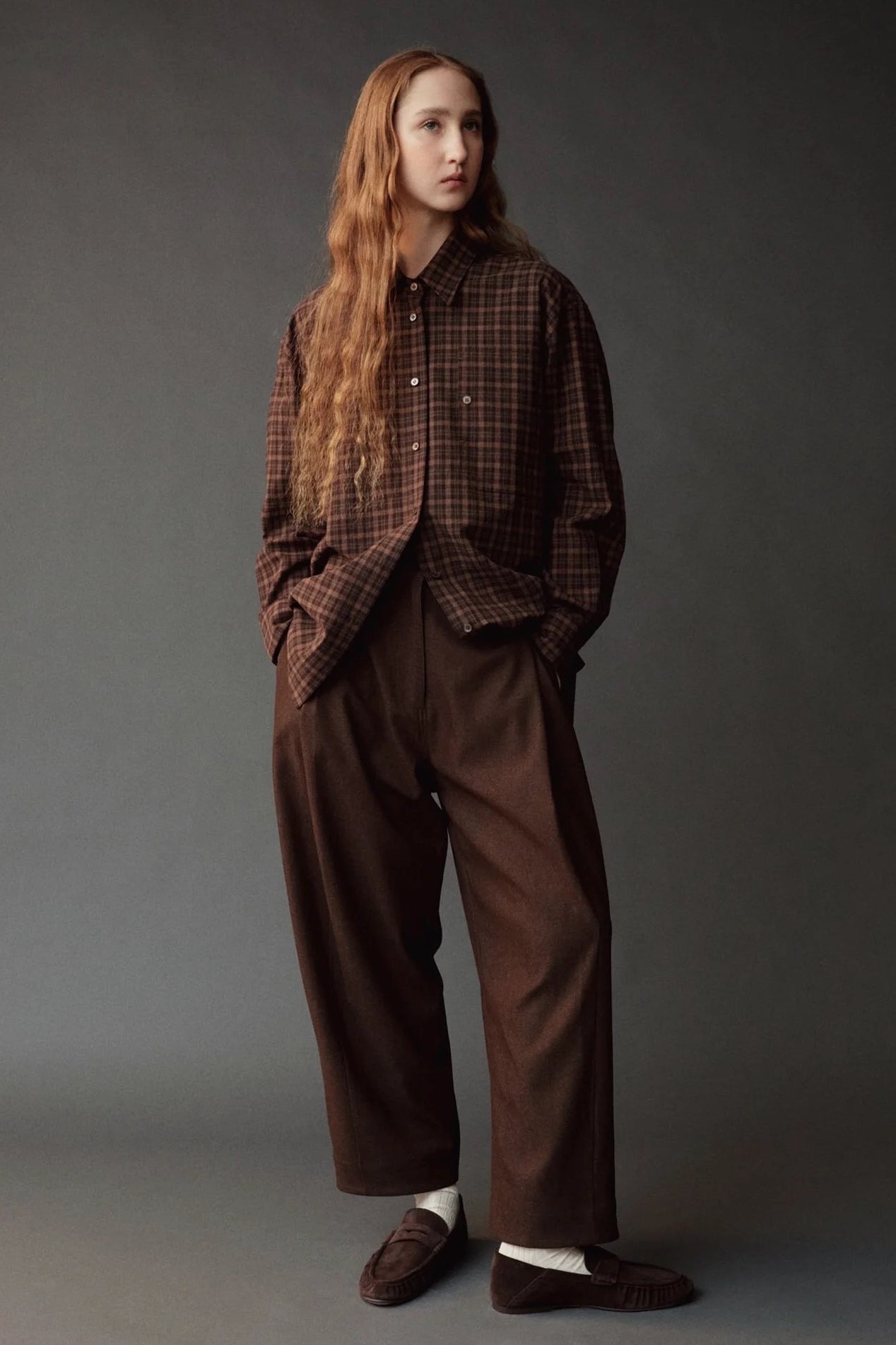 Front view of the Mijeong Park brown plaid shirt styled with relaxed brown trousers